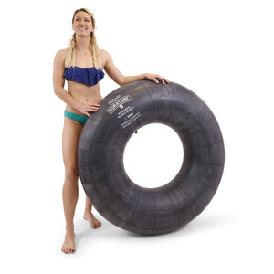 a woman in a bikini holding a large inflatable