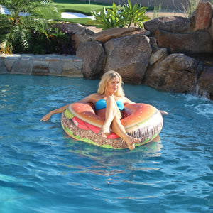 a woman in a pool with a float