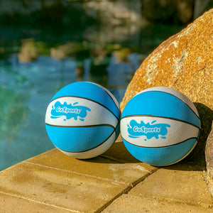 two blue and white balls sitting on a rock