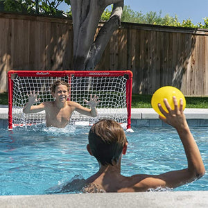 child holding yellow ball in the pool with polo goal set in background